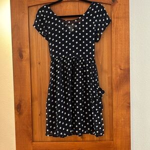 Navy blue short sleeve polkadot dress, tie back and pockets, and built in slip